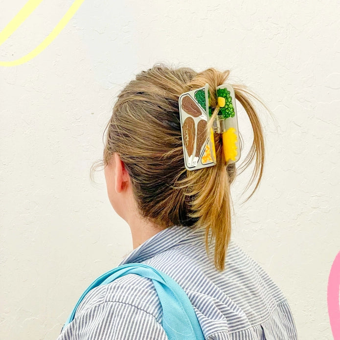 Hair claw in the hair of a model against a white background.