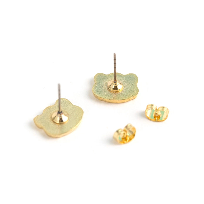 Back of earrings laying face down on a white background.