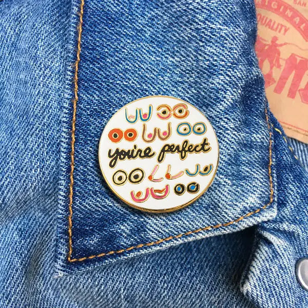 "You're Perfect" surrounded by various shapes of boobs on a denim jacket collar.