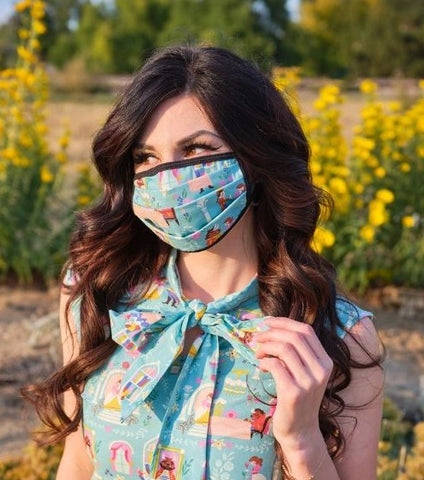 Female model wearing face mask against a garden background