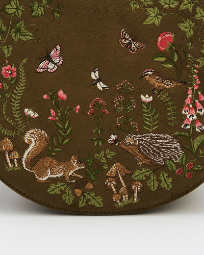 Close up details of the embroidered woodland creatures on the front of the purse.