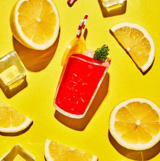 Hair claw against a yellow background with lemon slices and ice cubes.