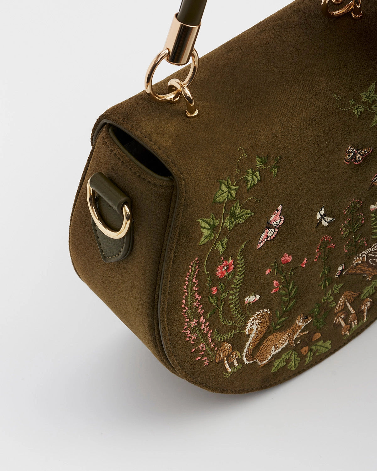 Front of the saddle bag at an angle showing the gold metal details against a white background.