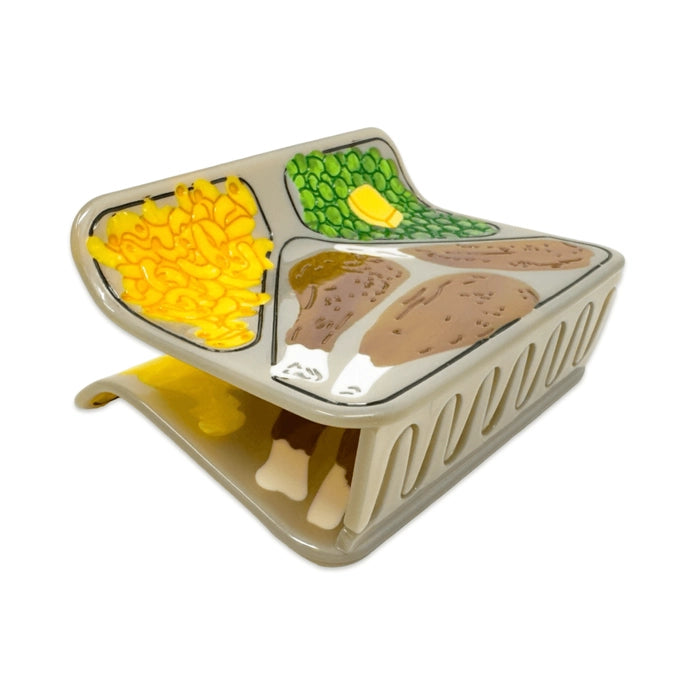 TV dinner hair claw at an angle showing the teeth of the claw against a white background.