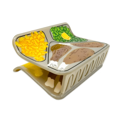 TV dinner hair claw at an angle showing the teeth of the claw against a white background.