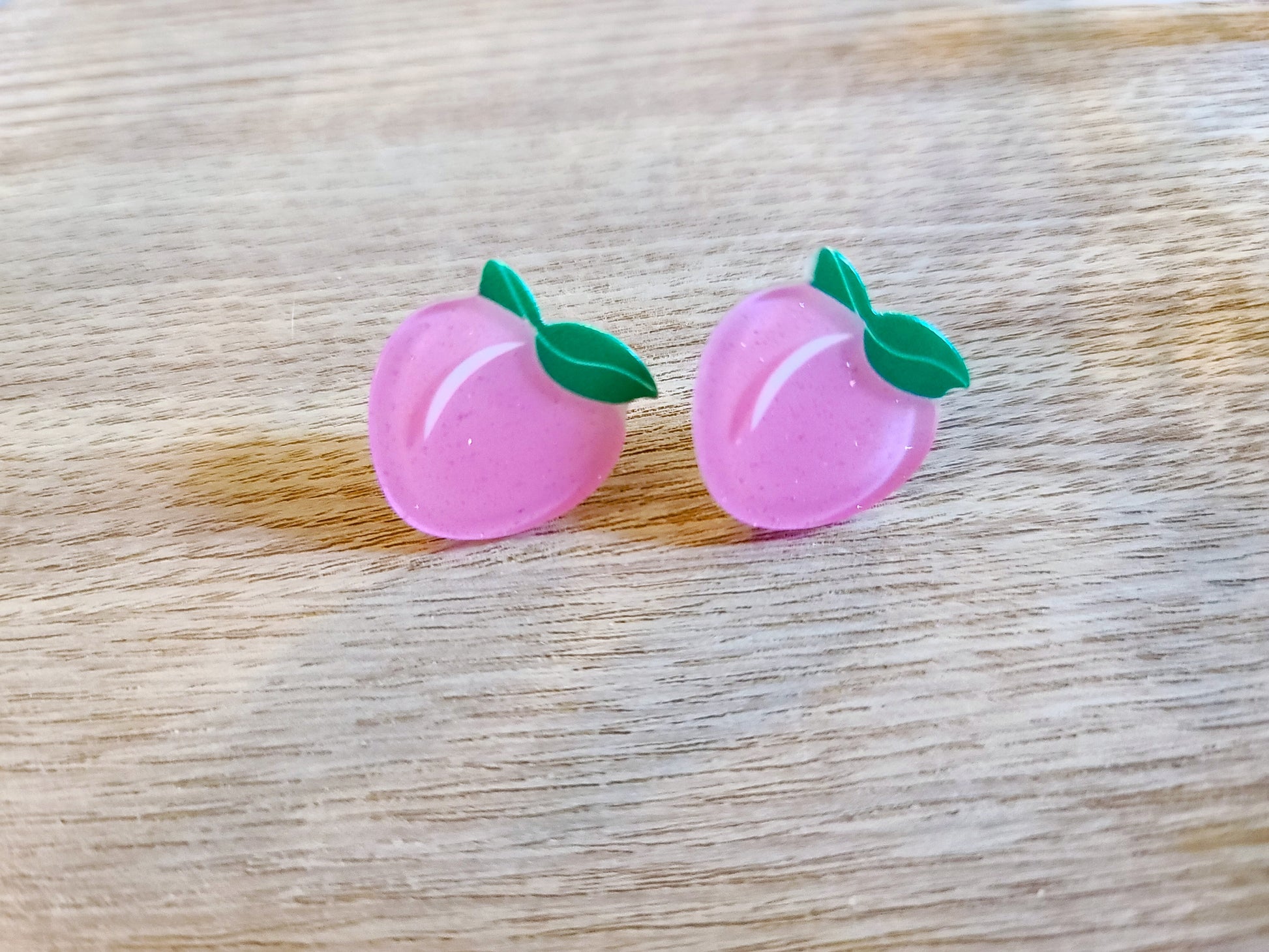 Earrings against wood background