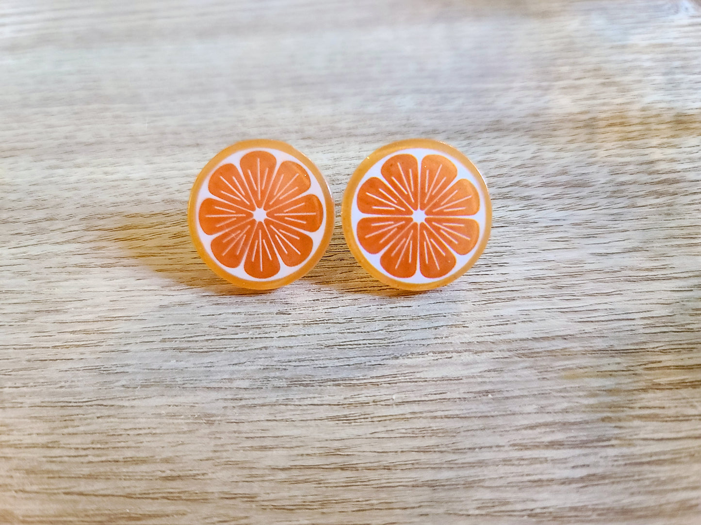 Earrings against wood background