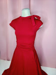 Dress on a mannequin against a pink background 