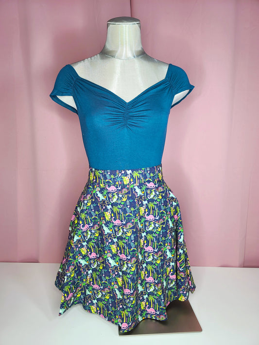 Top on mannequin with skirt against a pink background 