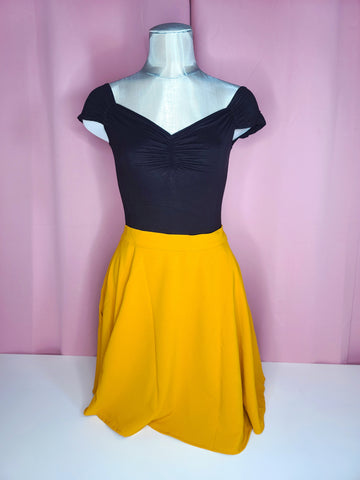 Skirt shown with top against a pink background