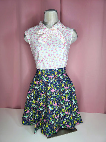 Top paired with skirt against a pink background