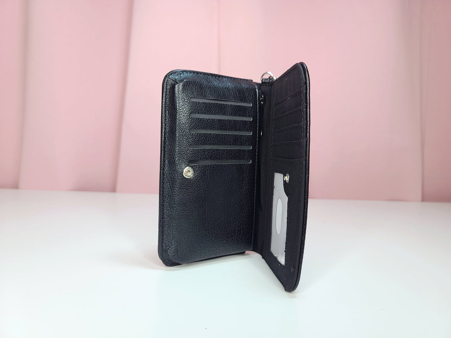 Inside of wallet against a pink background