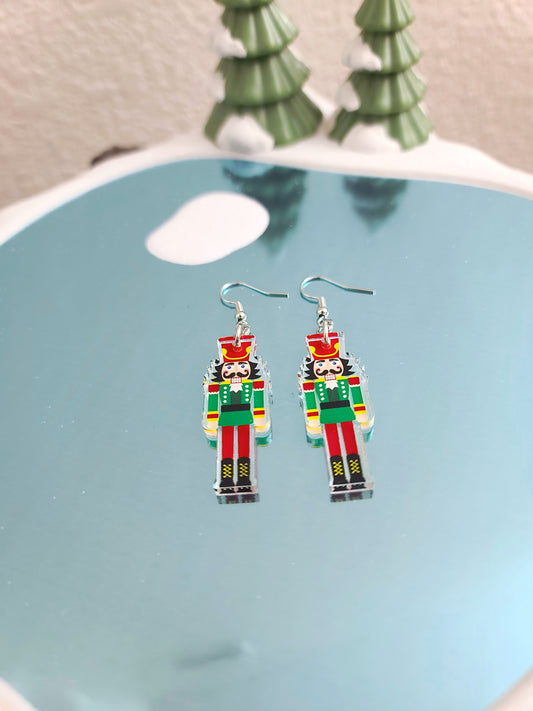 Nutcracker Earrings on glittering blue ice background