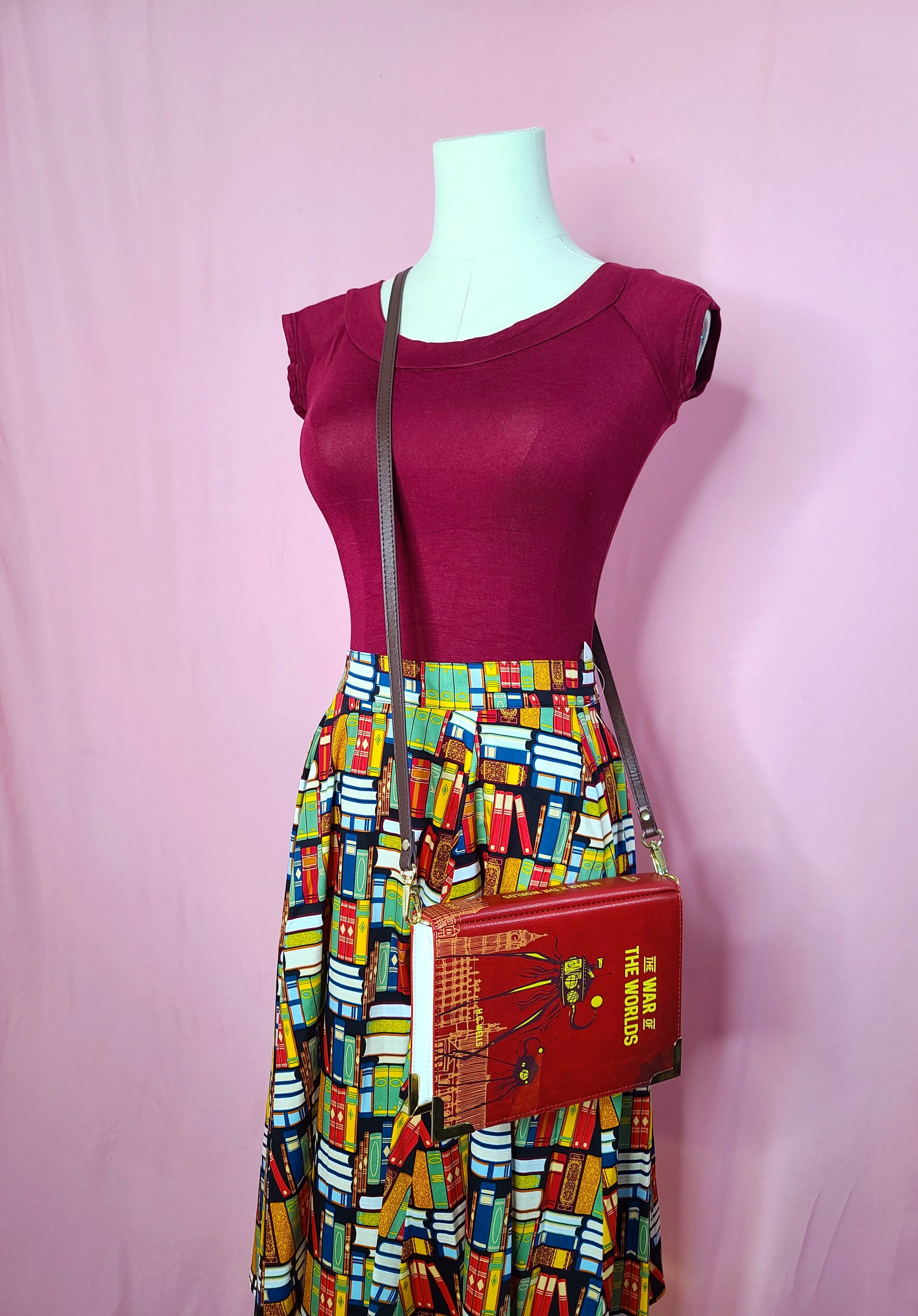 Skirt shown with Retro Boatneck Top in Burgundy, andThe War of the Worlds Dark Red Book Crossbody on a mannequin against a pink background