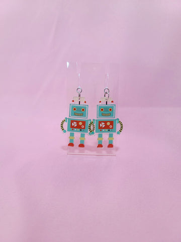 Earrings shown with the plastic hook option against a light pink background