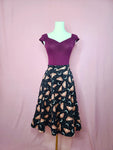 Skirt shown with Isabel Top in Plum on a mannequin against a pink background