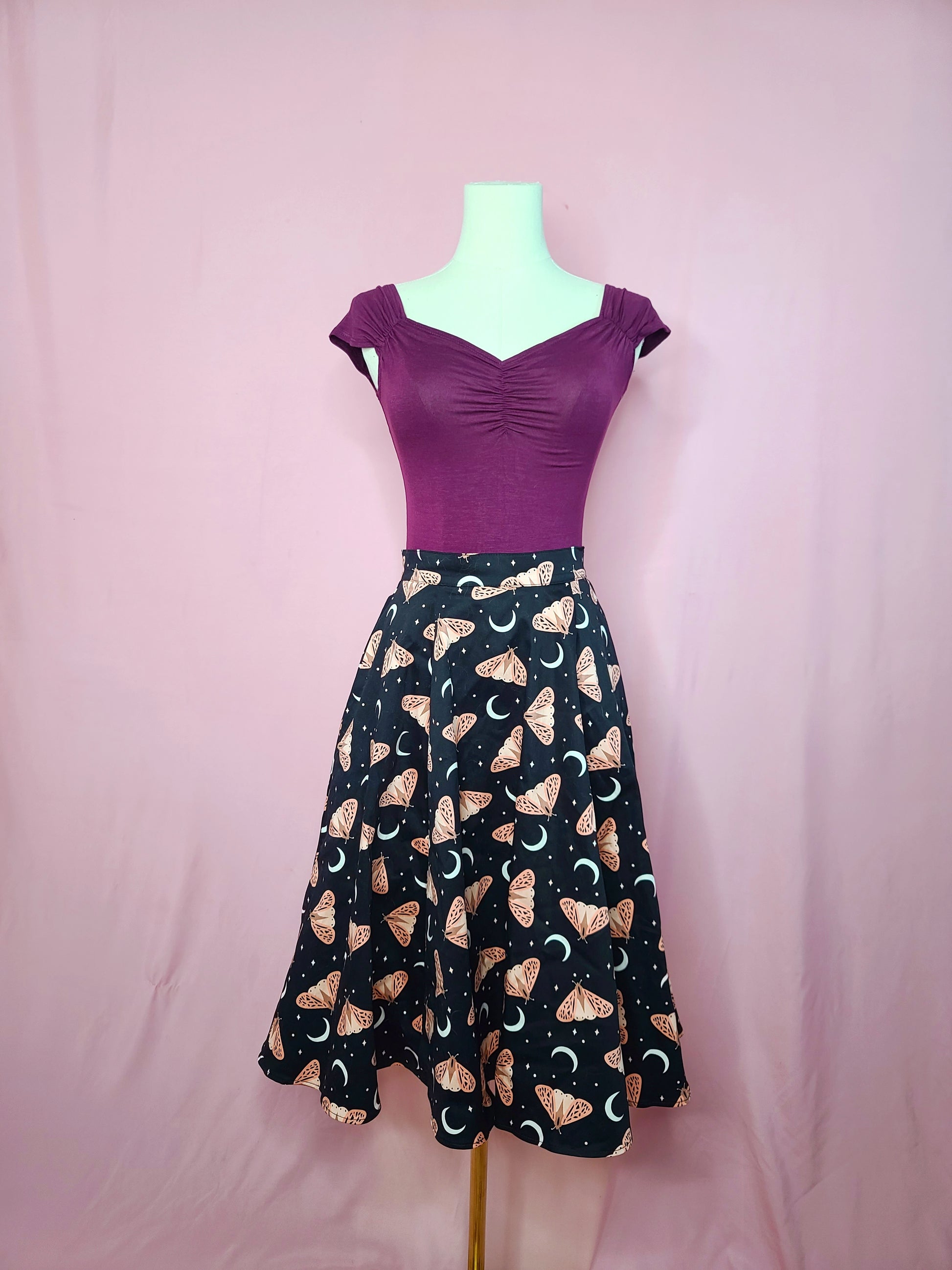 Top shown with Fit & Flare Moon & Butterfly Print Skirt on a mannequin against a pink background