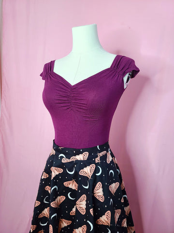 Top shown with Fit & Flare Moon & Butterfly Print Skirt on a mannequin against a pink background