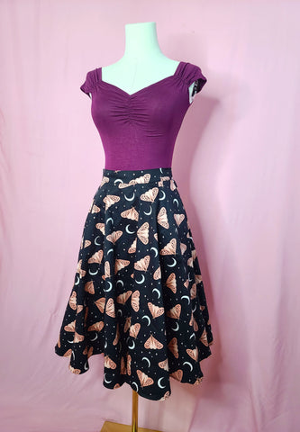 Skirt shown with Isabel top in Plum on a mannequin against a pink background