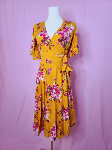 Front of dress on a mannequin against a pink background