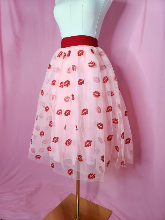 Skirt on a white mannequin against a pink background.