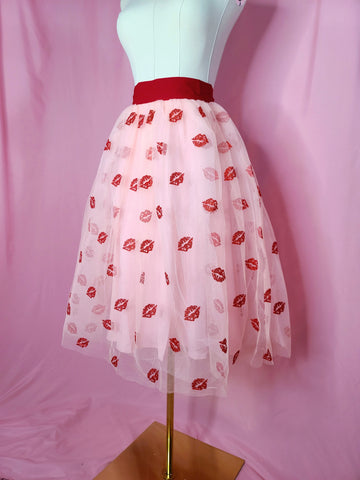 Skirt on mannequin against a pink background