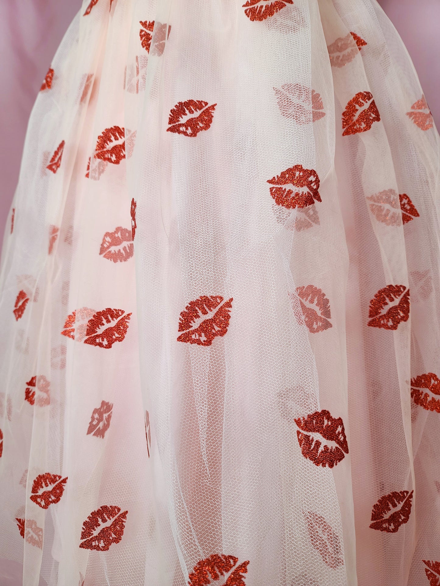 Close up of the red glitter lip fabric on the skirt