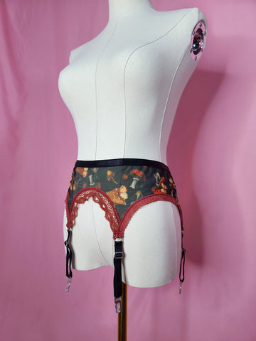 Garter on a white mannequin against a pink background