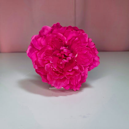 Hair flower against a pink and white background