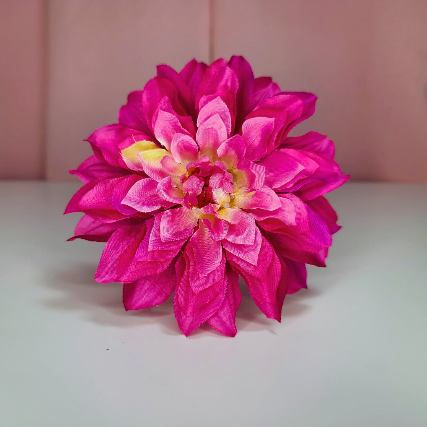 Hair flower against a white and pink background