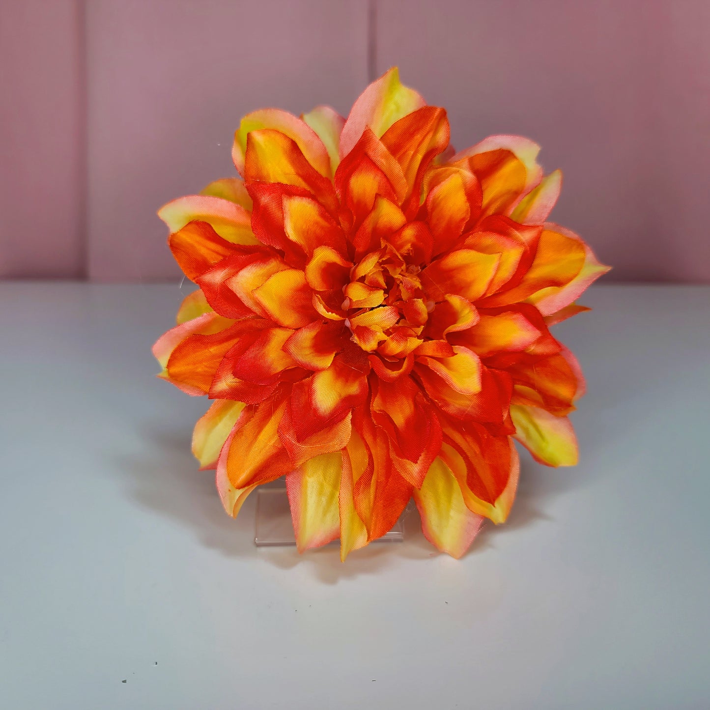 Hair flower against a white and pink background