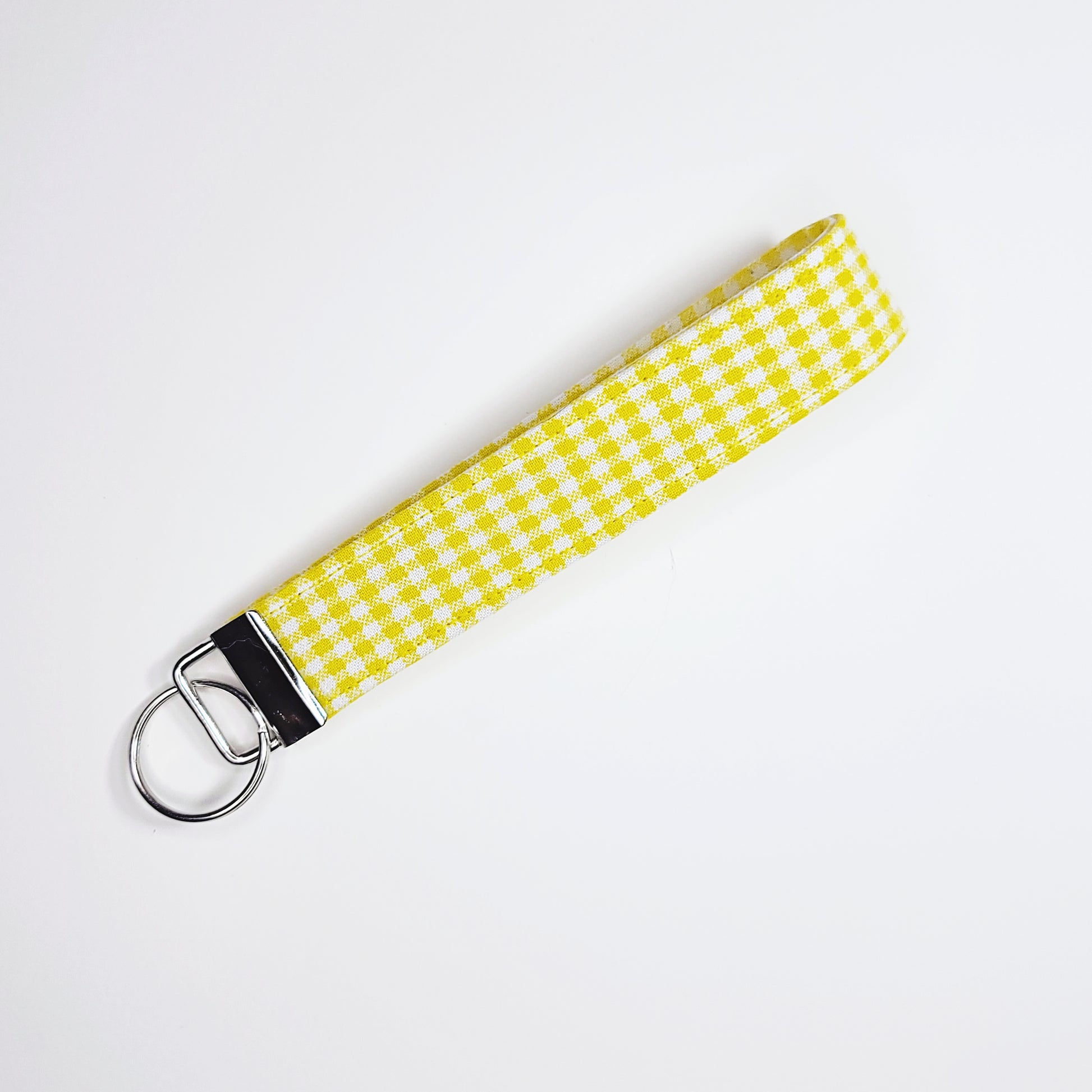 Yellow gingham key loop against a white background