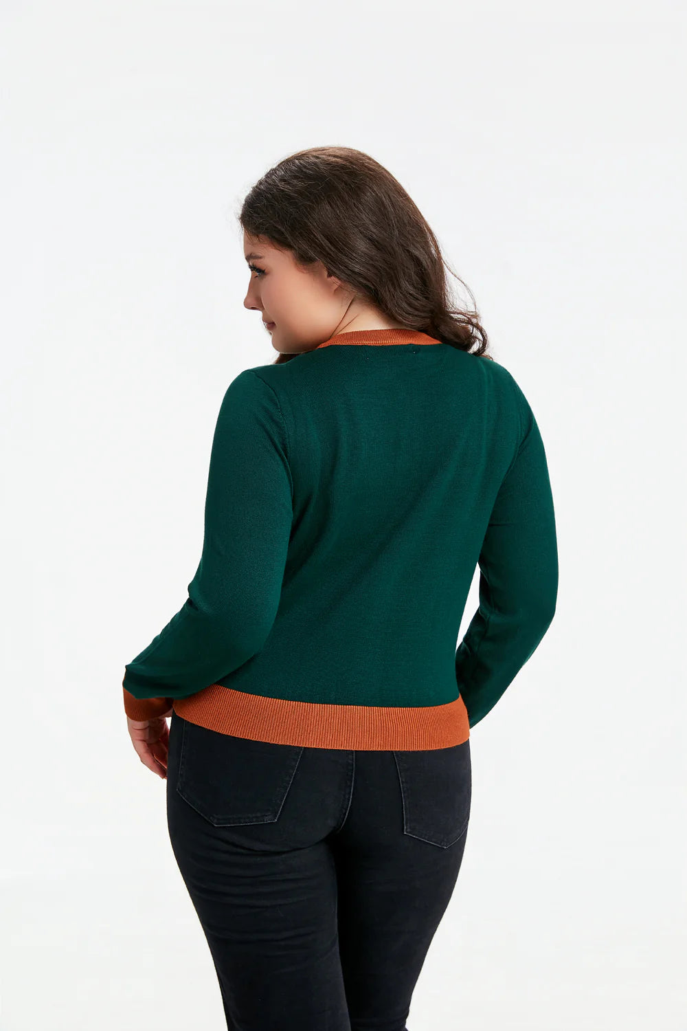 Female model wearing the Leslie Mushroom cardigan facing away to show the back of the cardigan against a white background.