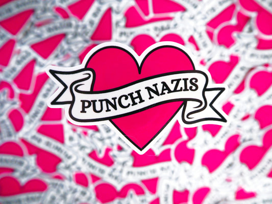 Heart-shaped sticker with 'Punch Nazis' text on a pink and gray patterned background.