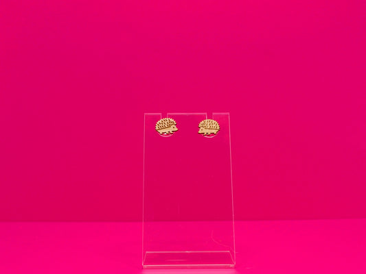 Light brown wood hedgehog earrings against a hot pink background.