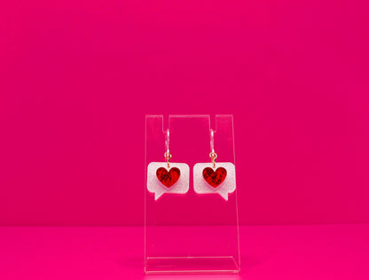 Red hearts on white text bubble earrings on a clear display against a pink background. Shown with plastic hook option.