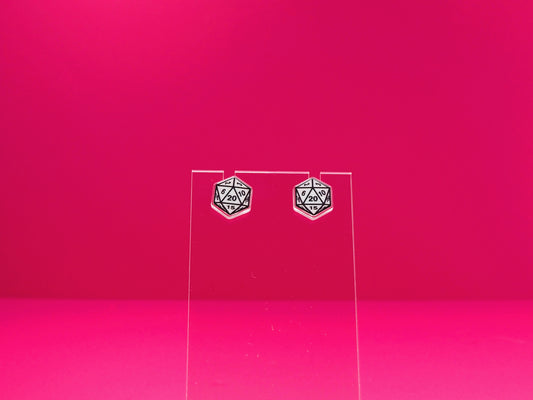 D20 dice earrings on a clear display against a pink background.