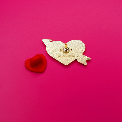 Gold back of pin with the red rubber back on the left.