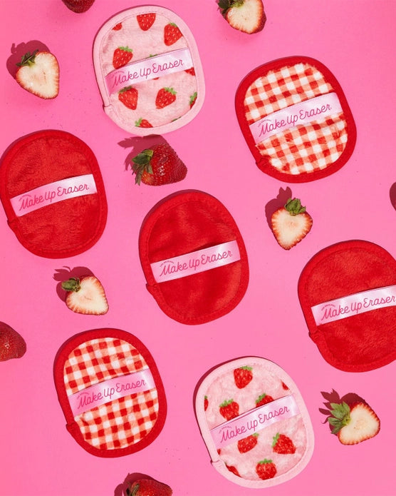 Alternating makeup eraser designs with cut open strawberries against a pink background