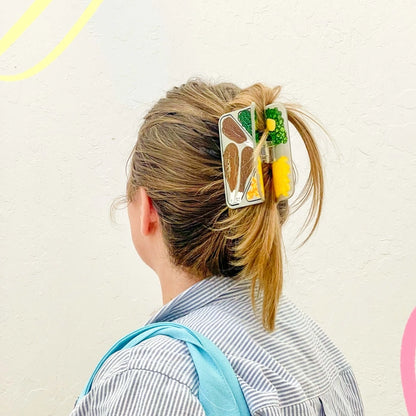 Hair claw in the hair of a model against a white background.