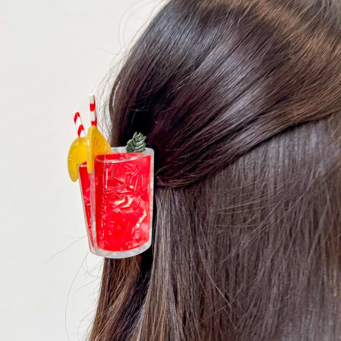 Hair claw shown in the hair of a model with dark brown hair against a white background.