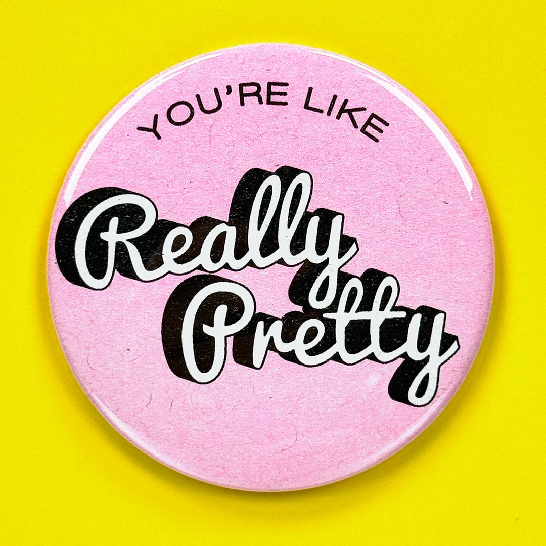 Mirror with "You're Like Really Pretty" in white and black lettering on pink against a yellow background.
