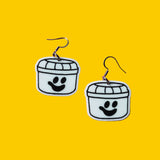 Earrings against yellow background