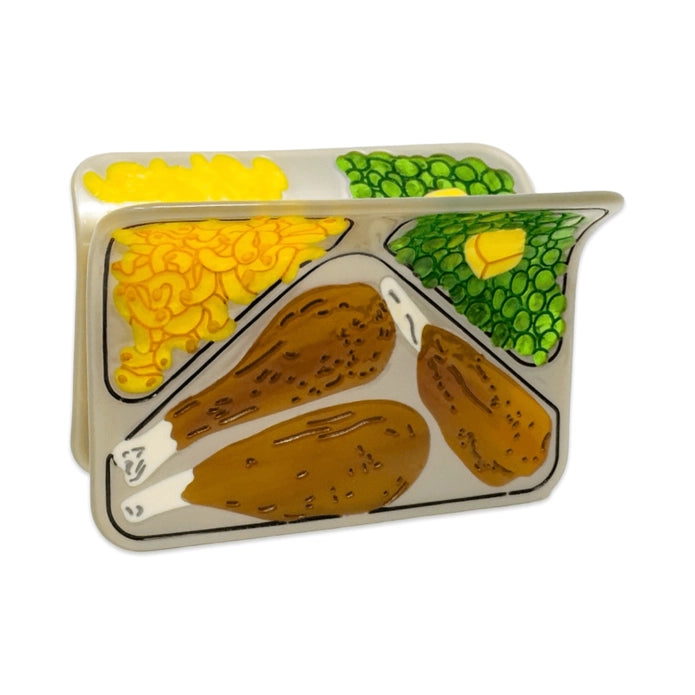 Front of the TV dinner hair claw against a white background.