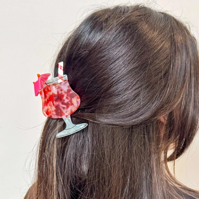 Hair claw shown in the hair of a model with dark brown hair against a white background.