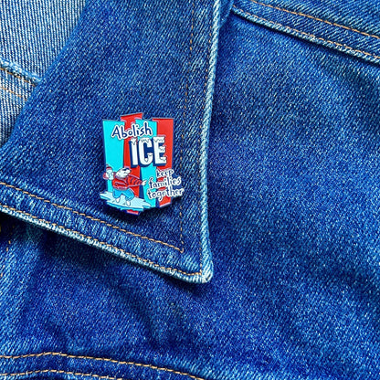 Red and blue enamel pin featuring the text 'Abolish ICE keep families together' with a cartoon polar bear surfing on ice.