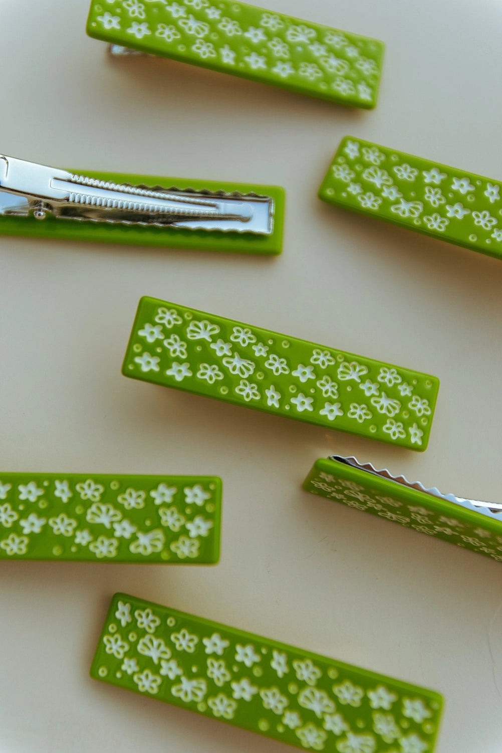 Multiple hair clips against a cream background.