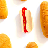 Hair claw surrounded by hot dog buns against a white background
