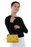 Model wearing a black long sleeve top showcasing the purse