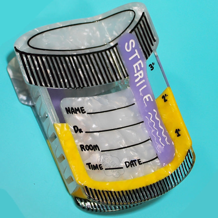 Sterile specimen cup hair claw against a blue background.